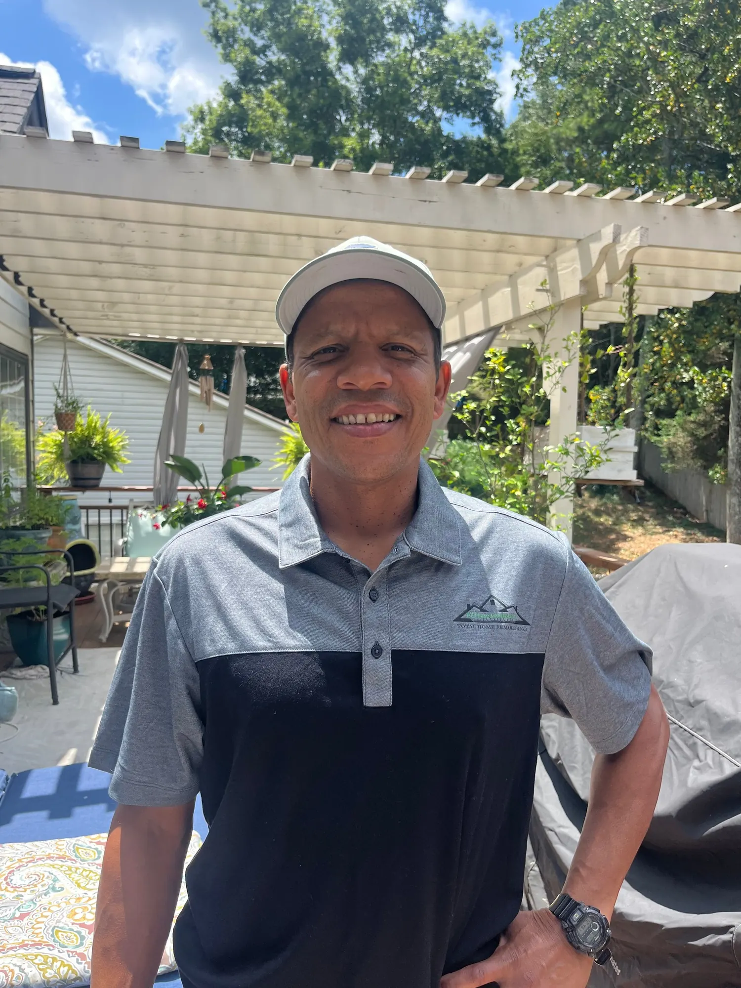 The owner of All Phase Contractors standing under a pergola he built