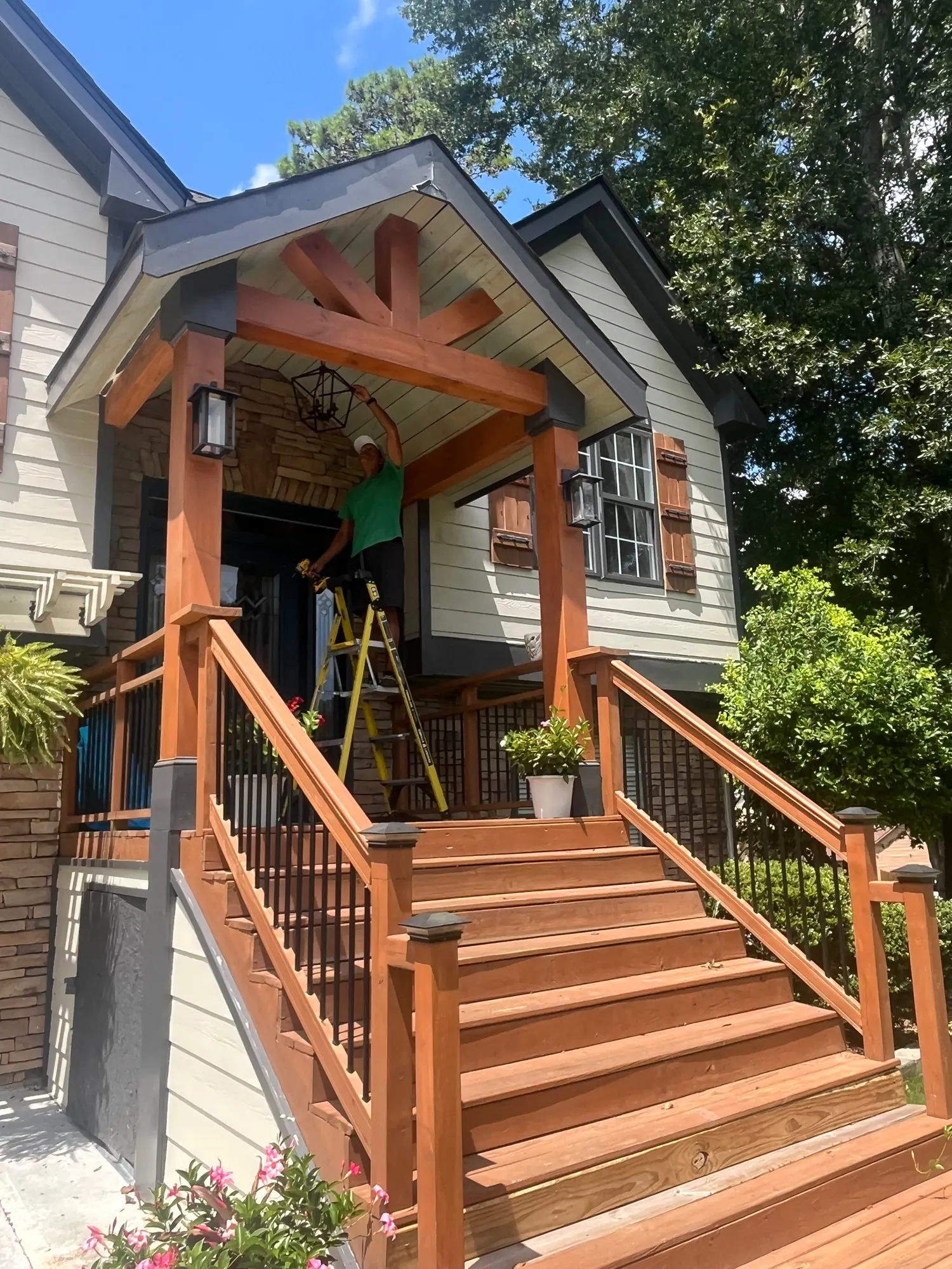 Timber-framed front porch and stained wood stairs under construction