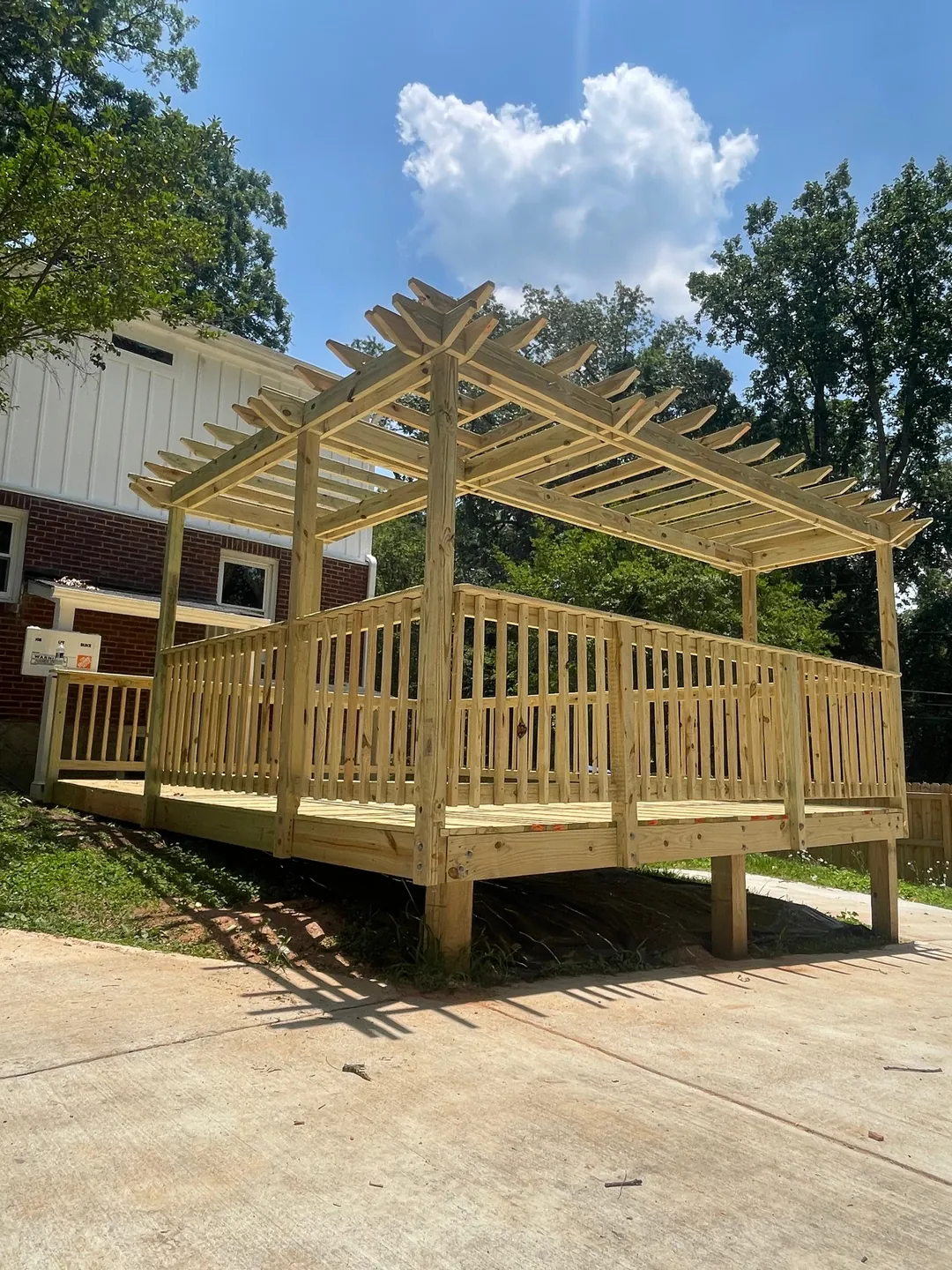 Pressure-treated pergola deck with railings