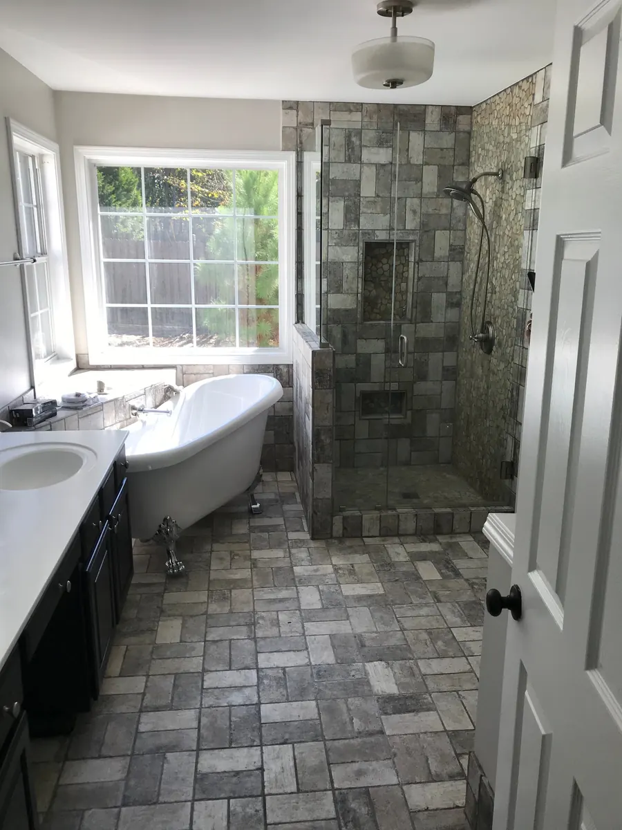 Bathroom with a clawfoot tub, walk-in shower and slate floor