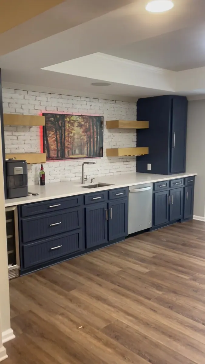 Navy kitchen with open shelving and a farmhouse sink